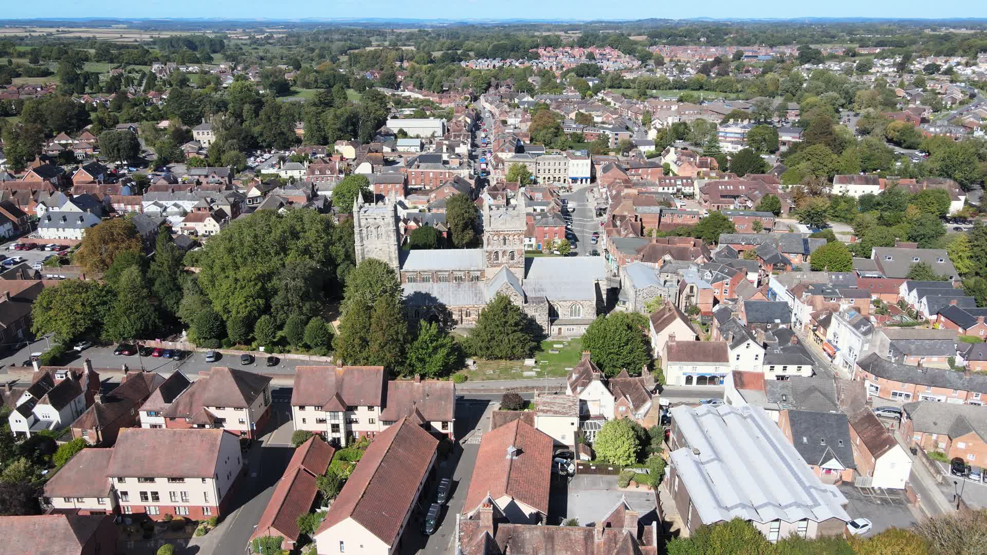 Aerial view of Wimborne Minster surrounded by the town's rooftops
